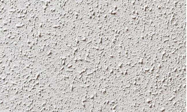 Textura rugosa da parede após aplicação de chapisco, pronta para receber o reboco